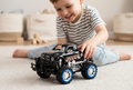 Niño jugando con el Monster Truck negro con detalles azules